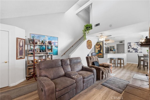 37940 42nd St E Unit 115, Palmdale, CA 93552 - living area with wood finished floors, high vaulted ceiling, a ceiling fan, stairs, and baseboards