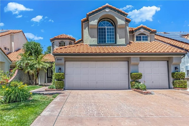 25455 Hardy Pl, Stevenson Ranch, CA 91381 - mediterranean / spanish home with driveway, a tiled roof, stucco siding, and a garage