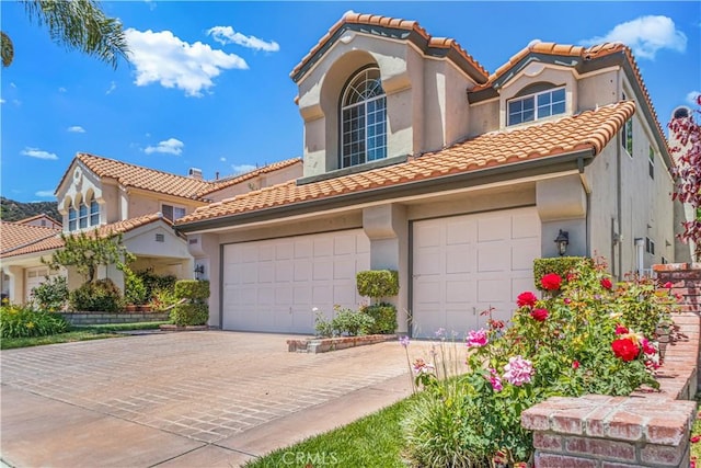 25455 Hardy Pl, Stevenson Ranch, CA 91381 - mediterranean / spanish-style home featuring a tile roof, stucco siding, driveway, and a garage
