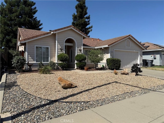 1438 Tumbleweed Ct, Oakdale, CA 95361 - single story home with a tiled roof, an attached garage, and concrete driveway