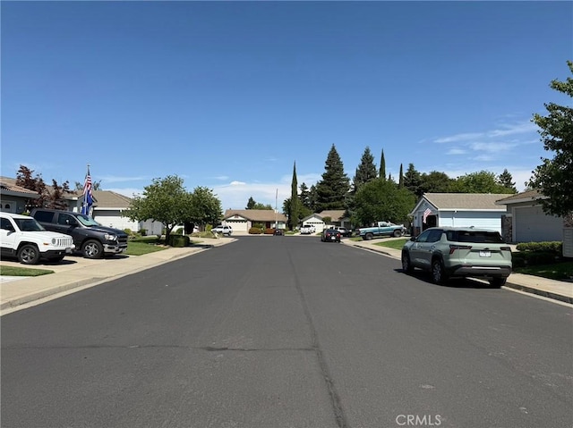 1438 Tumbleweed Ct, Oakdale, CA 95361 - view of asphalt street featuring curbs, sidewalks, and a residential view