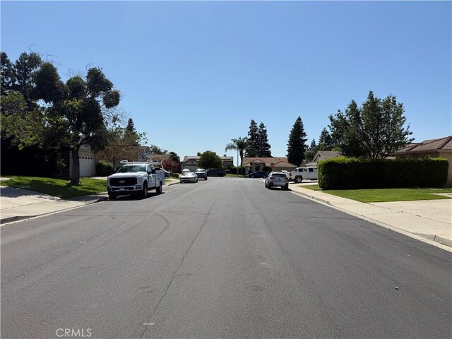 1438 Tumbleweed Ct, Oakdale, CA 95361 - view of asphalt street featuring curbs, a residential view, and sidewalks