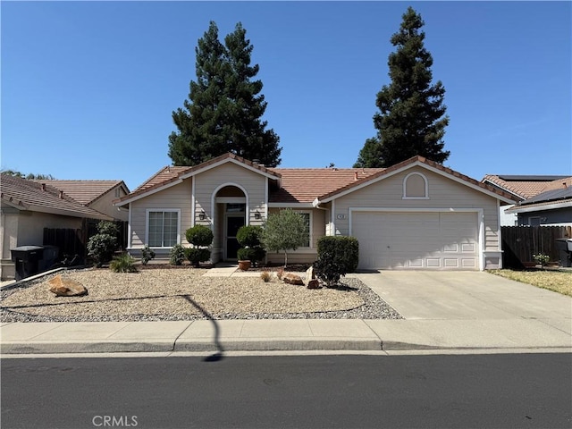 1438 Tumbleweed Ct, Oakdale, CA 95361 - ranch-style home with a tile roof, an attached garage, and driveway