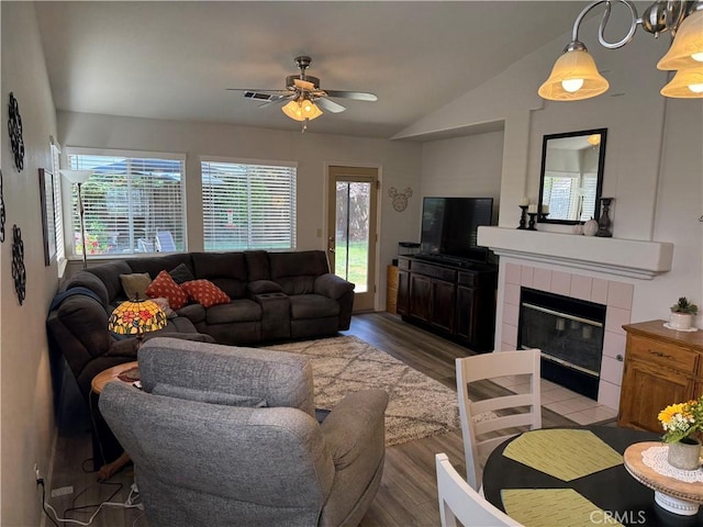 1438 Tumbleweed Ct, Oakdale, CA 95361 - living room with vaulted ceiling, ceiling fan, wood finished floors, and a fireplace
