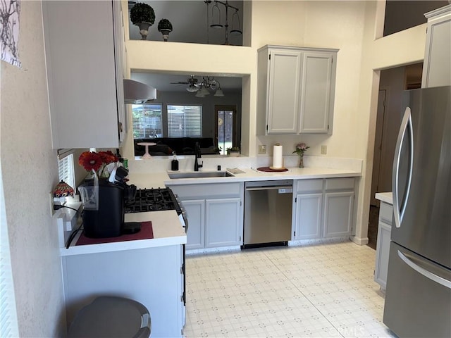 1438 Tumbleweed Ct, Oakdale, CA 95361 - kitchen featuring appliances with stainless steel finishes, a sink, light flooring, and light countertops