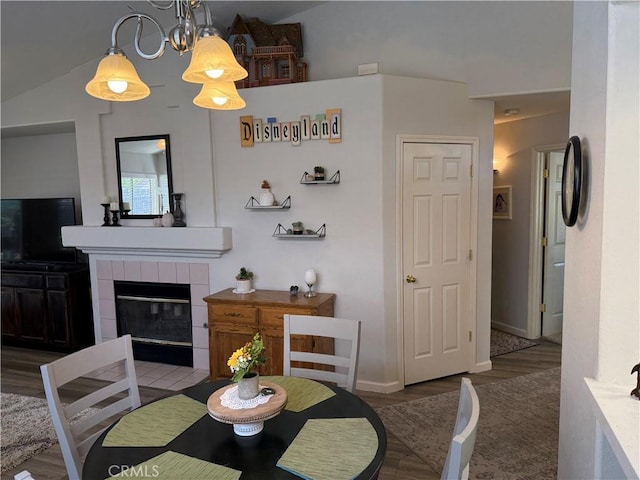1438 Tumbleweed Ct, Oakdale, CA 95361 - dining space with a tiled fireplace, wood finished floors, baseboards, and high vaulted ceiling