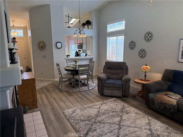 1438 Tumbleweed Ct, Oakdale, CA 95361 - living room with high vaulted ceiling, wood finished floors, and baseboards