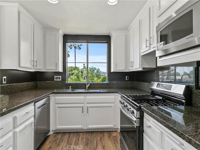 2 Vista Del Mar, Dana Point, CA 92629 - kitchen with appliances with stainless steel finishes, white cabinets, dark wood-type flooring, recessed lighting, and dark stone countertops