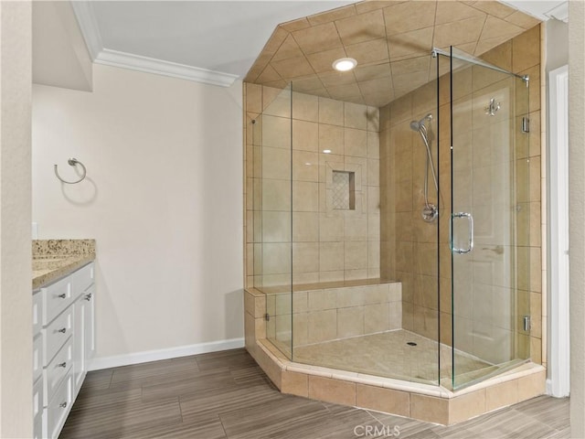 2 Vista Del Mar, Dana Point, CA 92629 - bathroom with a stall shower, vanity, ornamental molding, and wood finish floors