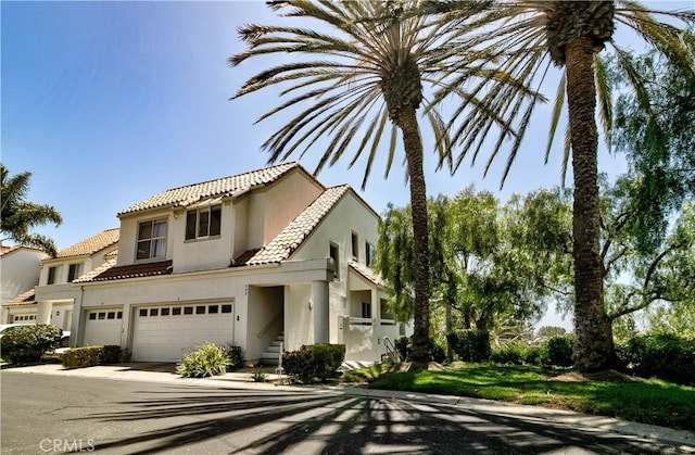 2 Vista Del Mar, Dana Point, CA 92629 - view of front of house with a tiled roof, stucco siding, a garage, and driveway
