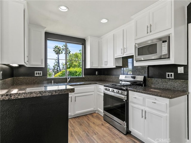 2 Vista Del Mar, Dana Point, CA 92629 - kitchen with appliances with stainless steel finishes, light wood-style floors, white cabinetry, recessed lighting, and dark stone counters