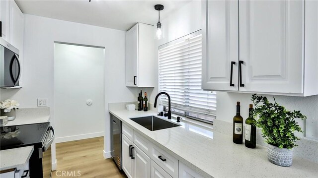 23331 Caminito Basilio Unit 348, Laguna Hills, CA 92653 - kitchen with a sink, stainless steel appliances, white cabinetry, and light wood-style flooring