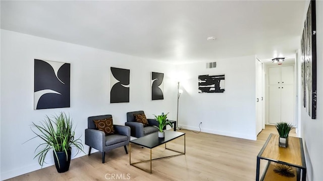 23331 Caminito Basilio Unit 348, Laguna Hills, CA 92653 - living room featuring light wood-style floors and baseboards