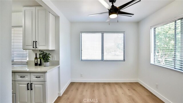 23331 Caminito Basilio Unit 348, Laguna Hills, CA 92653 - unfurnished dining area with ceiling fan, light wood-style floors, and baseboards