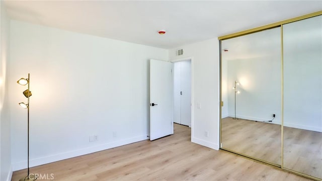 23331 Caminito Basilio Unit 348, Laguna Hills, CA 92653 - unfurnished bedroom with light wood-type flooring, a closet, and baseboards