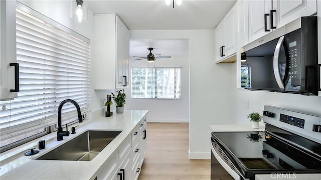 23331 Caminito Basilio Unit 348, Laguna Hills, CA 92653 - kitchen featuring appliances with stainless steel finishes, a sink, a ceiling fan, white cabinetry, and healthy amount of natural light