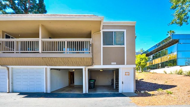 23331 Caminito Basilio Unit 348, Laguna Hills, CA 92653 - back of house featuring a balcony, an attached garage, and stucco siding