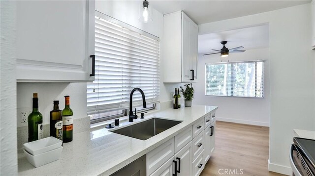 23331 Caminito Basilio Unit 348, Laguna Hills, CA 92653 - kitchen featuring a sink, a ceiling fan, white cabinets, and stainless steel range oven