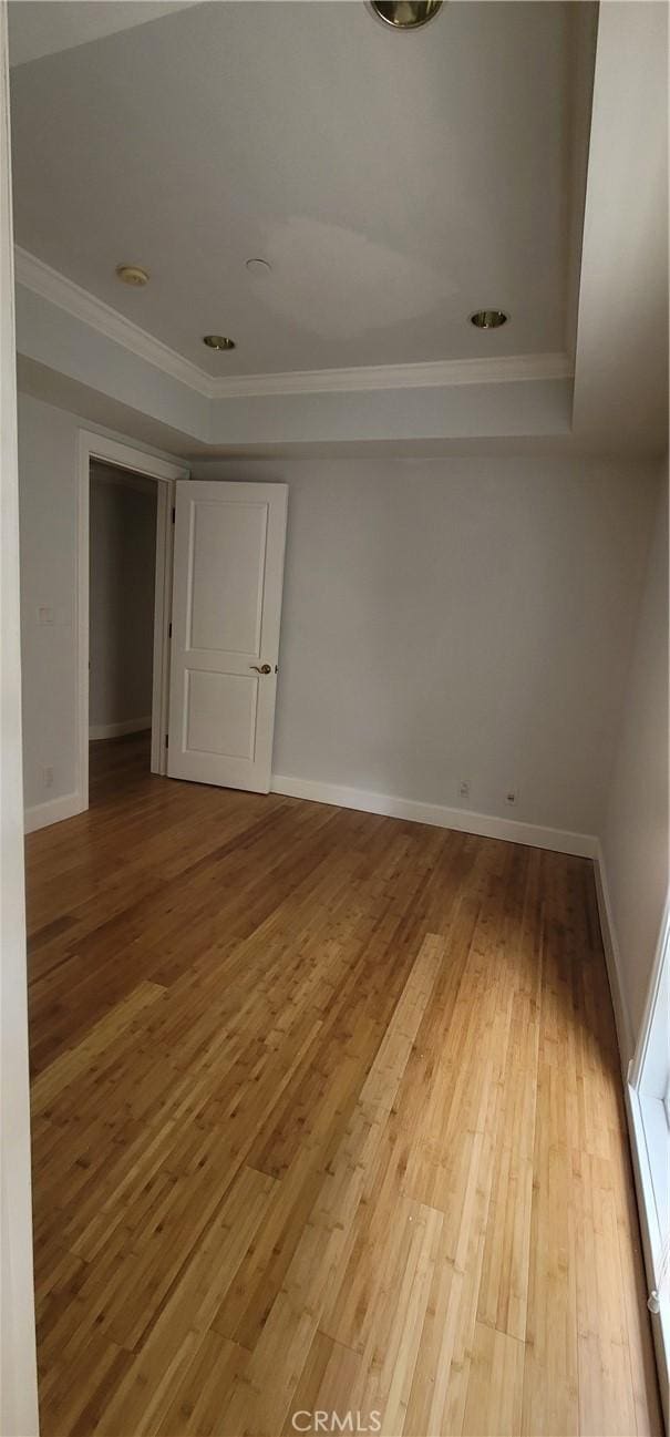 448 N Oakhurst Dr Unit 1, Beverly Hills, CA 90210 - unfurnished room with ornamental molding, wood-type flooring, baseboards, and a tray ceiling
