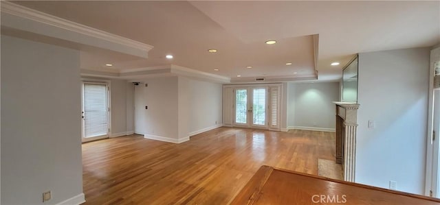 448 N Oakhurst Dr Unit 1, Beverly Hills, CA 90210 - unfurnished living room featuring a raised ceiling, baseboards, recessed lighting, light wood finished floors, and ornamental molding