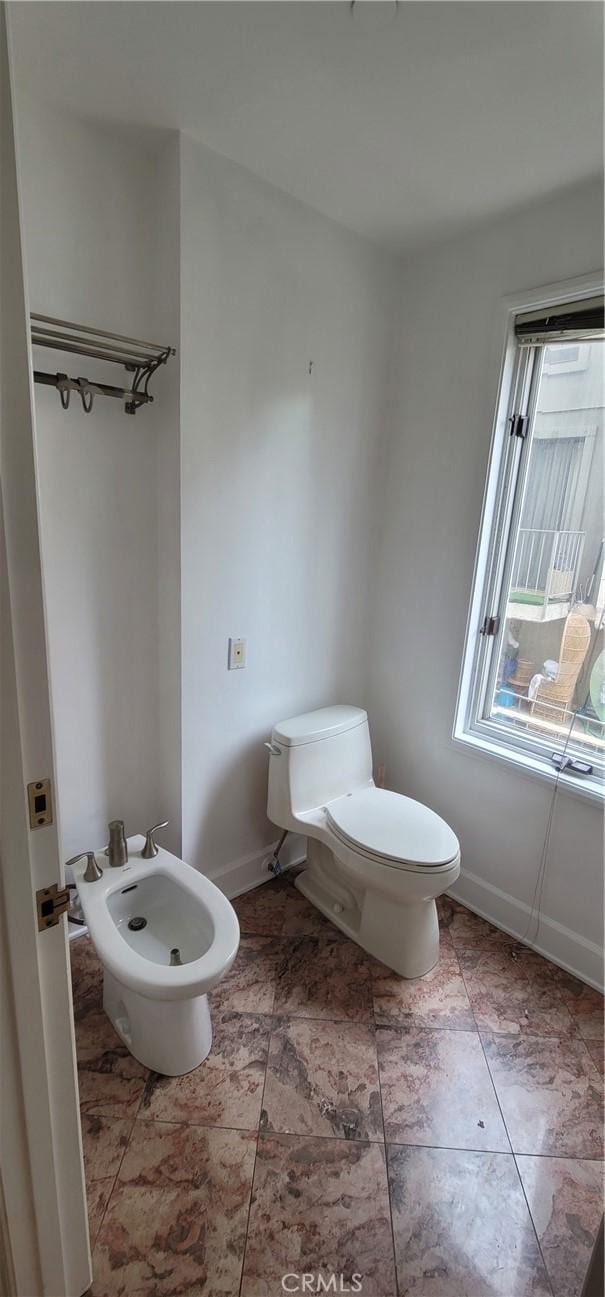 448 N Oakhurst Dr Unit 1, Beverly Hills, CA 90210 - half bath featuring a bidet, toilet, and baseboards
