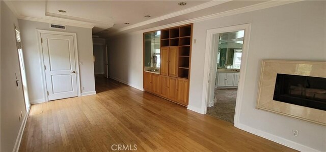 448 N Oakhurst Dr Unit 1, Beverly Hills, CA 90210 - spare room with ornamental molding, light wood-type flooring, baseboards, and a high end fireplace