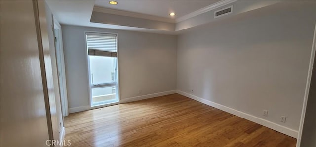 448 N Oakhurst Dr Unit 1, Beverly Hills, CA 90210 - empty room featuring ornamental molding, baseboards, light wood finished floors, a tray ceiling, and recessed lighting