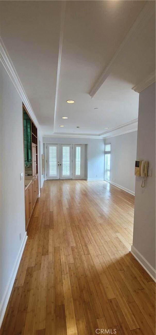 448 N Oakhurst Dr Unit 1, Beverly Hills, CA 90210 - unfurnished living room featuring light wood-style flooring, crown molding, and baseboards