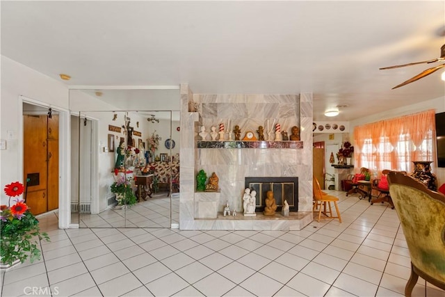 1140 Indian Summer Ave, La Puente, CA 91744 - living room with light tile patterned floors, ceiling fan, and a tiled fireplace
