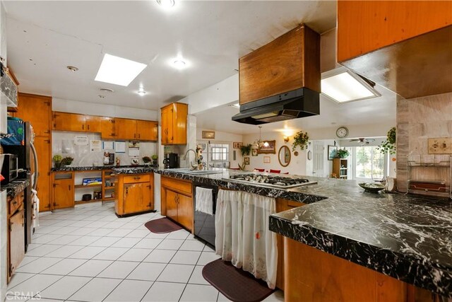 1140 Indian Summer Ave, La Puente, CA 91744 - kitchen featuring brown cabinets, stainless steel gas cooktop, dishwasher, a sink, and dark countertops