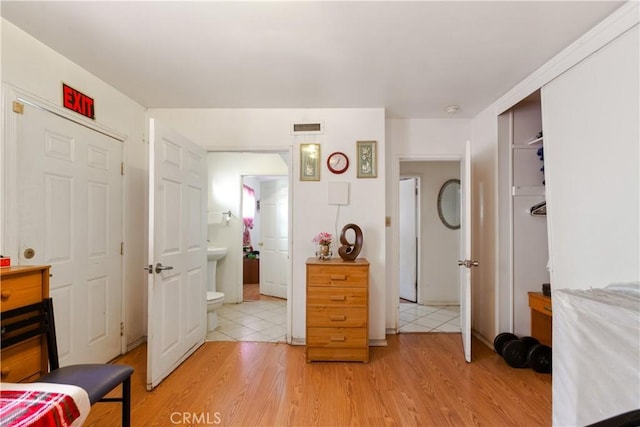 1140 Indian Summer Ave, La Puente, CA 91744 - bedroom with light wood-style floors, a closet, and ensuite bath