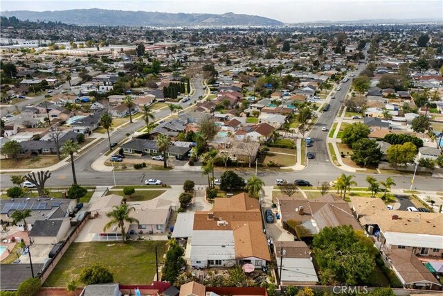 1140 Indian Summer Ave, La Puente, CA 91744 - aerial overview of property's location featuring a mountain backdrop and nearby suburban area