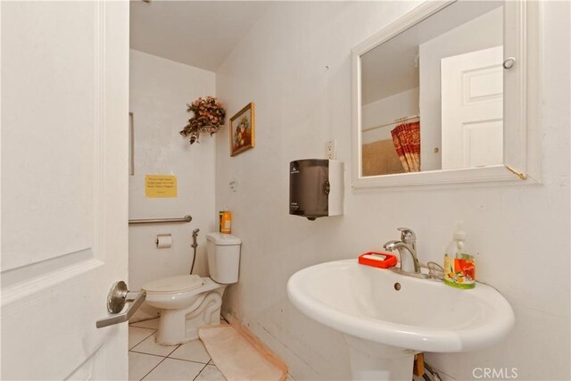 1140 Indian Summer Ave, La Puente, CA 91744 - bathroom featuring a sink, tile patterned flooring, and toilet