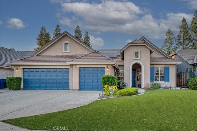 2737 Sussex Ave, Clovis, CA 93611 - traditional home featuring stucco siding, concrete driveway, roof mounted solar panels, an attached garage, and a tiled roof