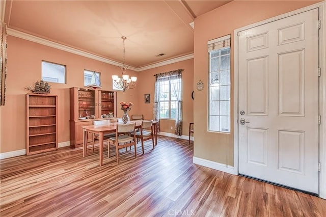 2737 Sussex Ave, Clovis, CA 93611 - dining area with light wood-style floors, a chandelier, baseboards, and ornamental molding
