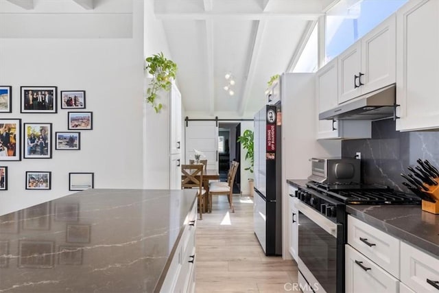 19842 Gilmore St, Woodland Hills, CA 91367 - kitchen featuring range with gas cooktop, under cabinet range hood, a barn door, decorative backsplash, and light wood finished floors