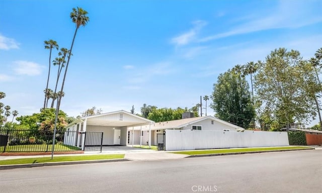 19842 Gilmore St, Woodland Hills, CA 91367 - view of front facade with driveway, an attached carport, and a gate