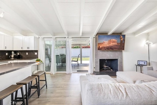 19842 Gilmore St, Woodland Hills, CA 91367 - living room featuring beamed ceiling, light wood-type flooring, and a fireplace