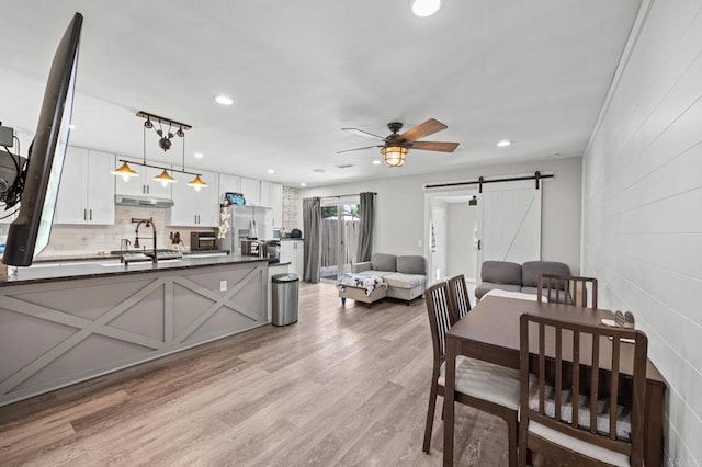 257 Holiday Way, Oceanside, CA 92057 - dining room with a barn door, a ceiling fan, light wood-type flooring, and recessed lighting