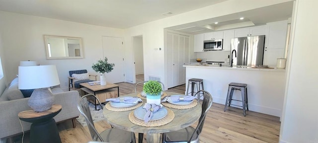 742 Eastshore, Chula Vista, CA 91913 - dining area featuring light wood-style flooring, baseboards, and a tray ceiling