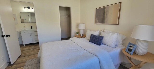 742 Eastshore, Chula Vista, CA 91913 - bedroom with wood finished floors, a closet, ensuite bath, a sink, and baseboards