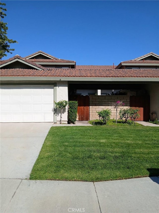 28948 Marilyn Dr, Canyon Country, CA 91387 - ranch-style home featuring a front lawn, driveway, an attached garage, stucco siding, and a tiled roof