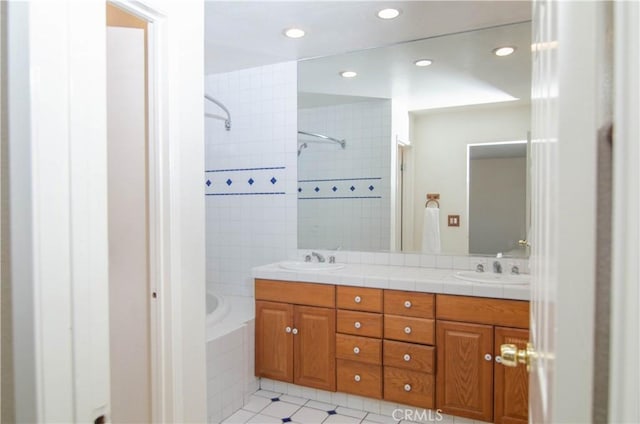 28948 Marilyn Dr, Canyon Country, CA 91387 - bathroom featuring double vanity, tile patterned floors, recessed lighting, and tiled shower / bath combo