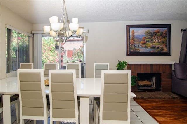 28948 Marilyn Dr, Canyon Country, CA 91387 - dining area featuring a chandelier, a textured ceiling, tile patterned floors, and a fireplace