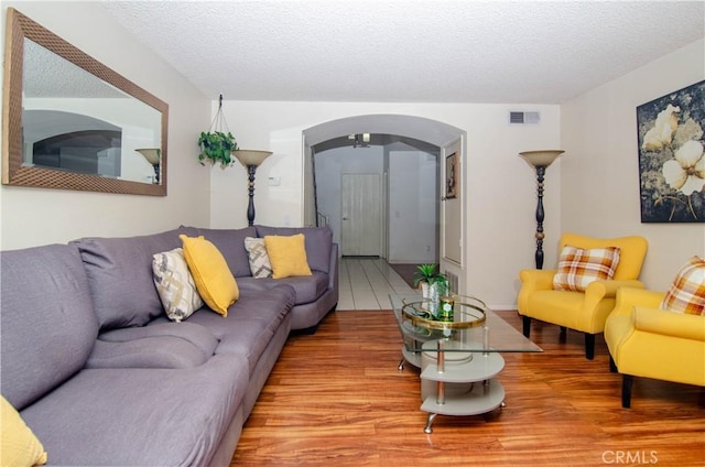 28948 Marilyn Dr, Canyon Country, CA 91387 - living room with arched walkways, wood finished floors, and a textured ceiling