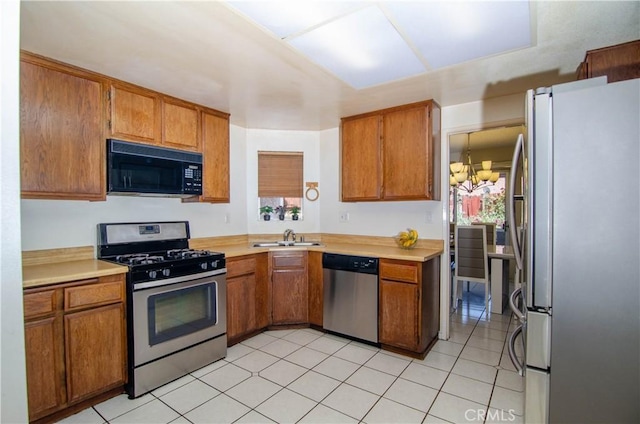 28948 Marilyn Dr, Canyon Country, CA 91387 - kitchen featuring appliances with stainless steel finishes, brown cabinets, and light countertops