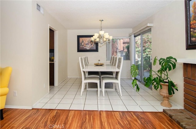 28948 Marilyn Dr, Canyon Country, CA 91387 - dining space with a chandelier, a textured ceiling, and baseboards