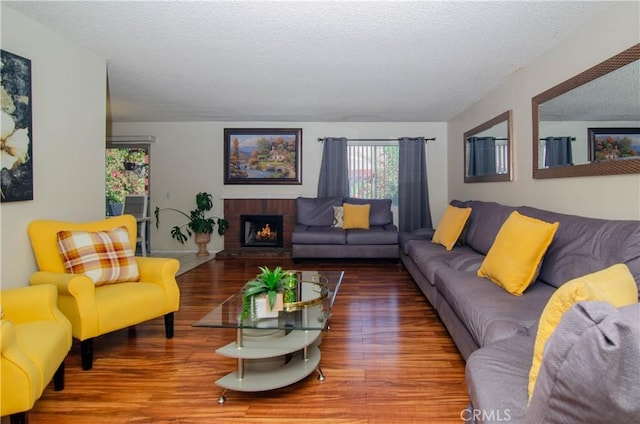28948 Marilyn Dr, Canyon Country, CA 91387 - living room featuring wood finished floors, a textured ceiling, and a fireplace