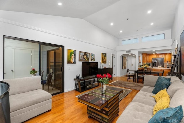 270 Cagney Ln Unit 315, Newport Beach, CA 92663 - living area featuring arched walkways, light wood-style floors, high vaulted ceiling, and recessed lighting