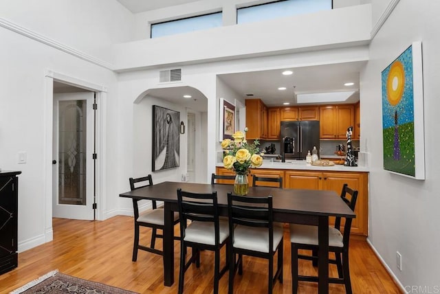 270 Cagney Ln Unit 315, Newport Beach, CA 92663 - dining room featuring light wood-type flooring, baseboards, arched walkways, and recessed lighting
